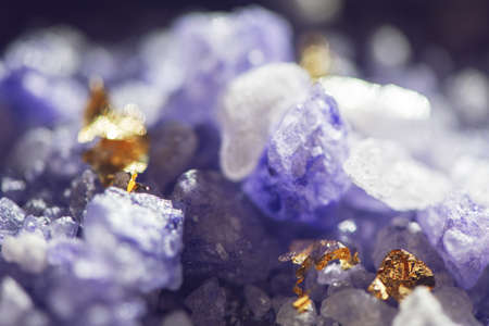Crystals of natural sea salt with gold foil close-up background.の写真素材