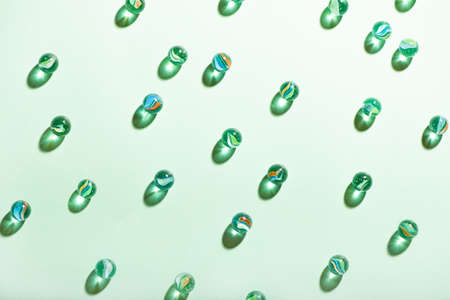 Little glass balls on mint background.の写真素材