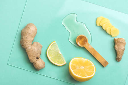 Honey, lemon and ginger on turquoise background.