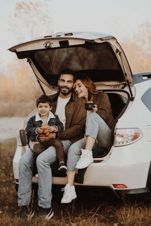 Happy family near the carの写真素材