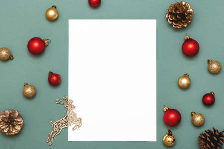 Christmas composition with paper blank and Christmas decoration on blue background.の写真素材