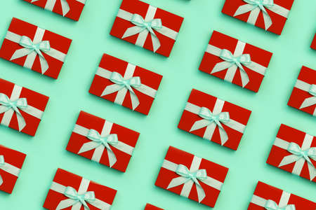 Flat lay with red colored gift boxes on green background.の写真素材