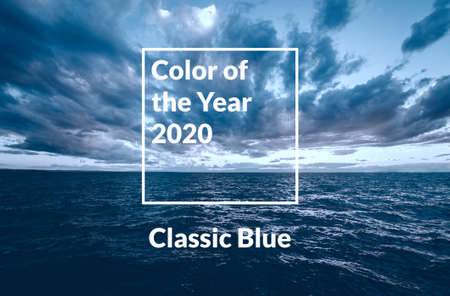 Sunset sea view with dramatic sky and colorful clouds toned in classic blue.の写真素材