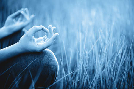 Man meditating outdoor in the park. Healthy and Yoga Concept.の写真素材