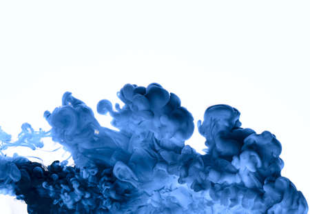 Colorful cloud of blue underwater paint on white background.の写真素材