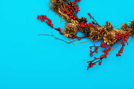 Partial view of Christmas wreath on blue background with copy space.の写真素材