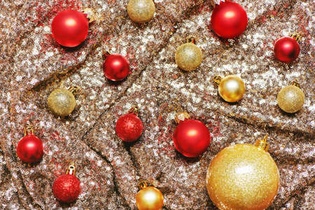 Christmas toys decoration balls on a sparkling sequins background.