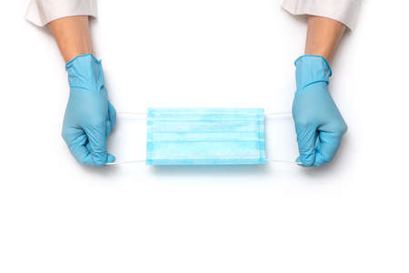 Hands holding medical protective mask on white background.