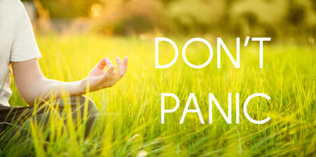 Man do meditation outdoor with Dont panic text.の写真素材