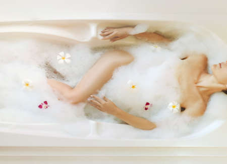 Beautiful woman relaxing in bath.の写真素材