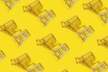 Shopping carts on yellow background.の写真素材