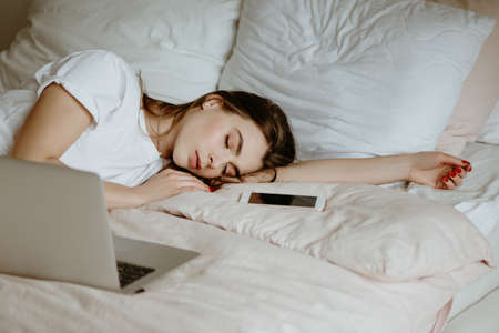 Woman fallen asleep while using computer.の写真素材