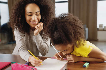Mother and daughter doing homework together.の写真素材