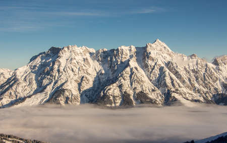 sunset view steinernes meer Saalbach hinterglemm leogang with mountains in sunset light and fog in...