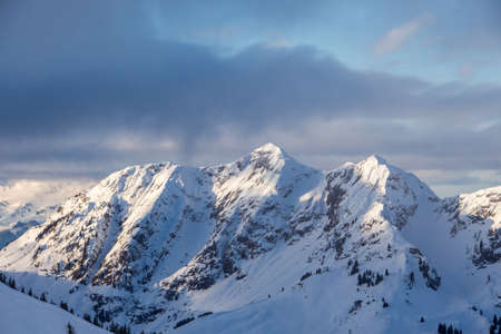 Birnhorn saalbach hinterglemm clouds and dramatic mood scenic. Weather was great but with dark clouds in perfect sunlight. mountainscape and landscape view of Austrian alpes, summit peak.の写真素材