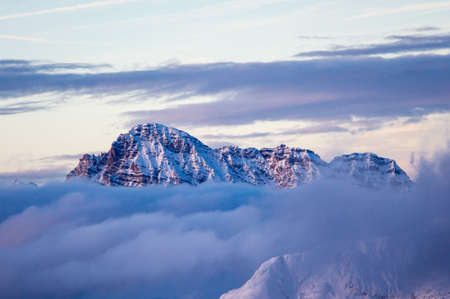 saalbach hinterglemm clouds sunset after a long skiing day in winter. Great mountain rock purple light and mood. mountainscape landscape sunset.の写真素材