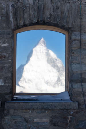 Perfect mirror view of the Matterhorn in Zermatt at a perfect sunny day, with blue sky and perfect light. The snowy Swiss mountains and landscape in winter is extraordinary. After a long skiing day these views are incredible.の写真素材