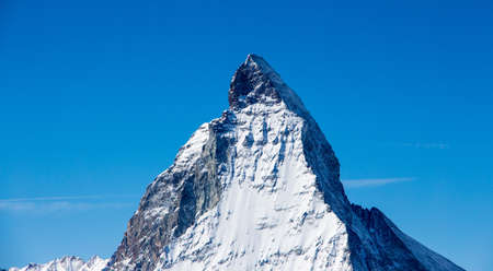 Perfect view of the Matterhorn in Zermatt at a perfect sunny day, with blue sky and perfect light. The snowy Swiss mountains and landscape in winter is extraordinary. After a long skiing day these views are incredible.の写真素材