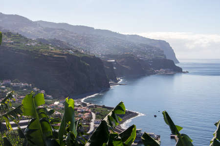 Beautiful madeira spectacular landscape with cliffs and small cities along the coastline of the high...