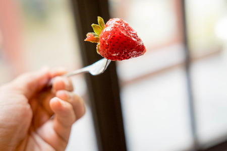 strawberry is color red on the spoonの写真素材