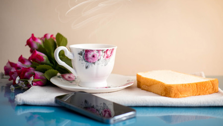 Morning is perfect for your favorite coffee,Coffee cup, soft coffee,Black coffee with bread Good for starting up in the morning.の写真素材