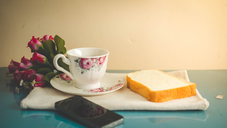 Morning is perfect for your favorite coffee,Coffee cup, soft coffee,Black coffee with bread Good for starting up in the morning.の写真素材