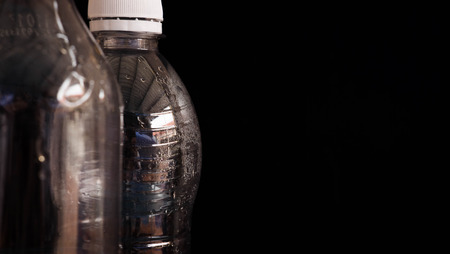 Water bottle, plastic bottles,water drops, empty bottles, black backdrop,close upの写真素材