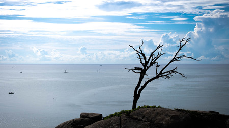 The sky has a lot of clouds and the bottom is sea-view from above.の写真素材