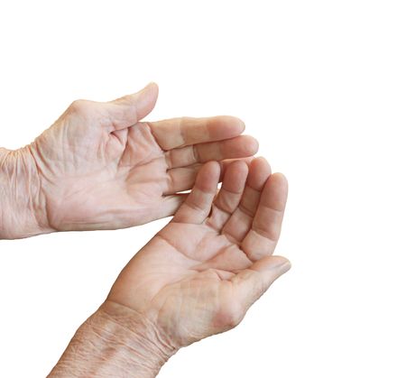 The old woman's hands folded in a handful of white backgroundの写真素材