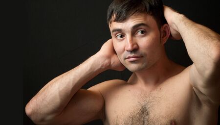 Handsome athlete on a black background の写真素材