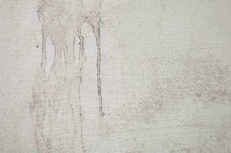 Water stained and grungy concrete wall with cracksの写真素材