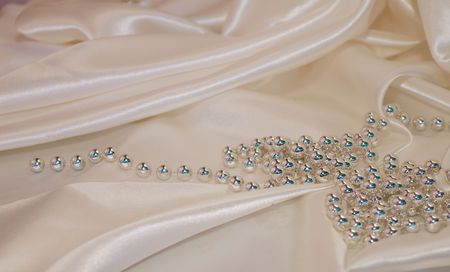   Pearls a necklace on a silk fabricの写真素材