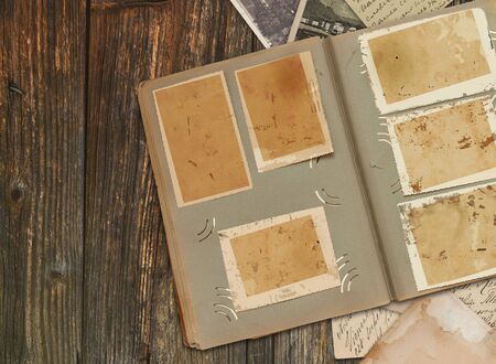 Vintage background with old photographs and feathers の写真素材