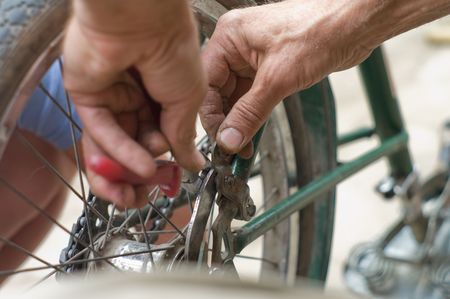 working hands repairing bicycle の写真素材