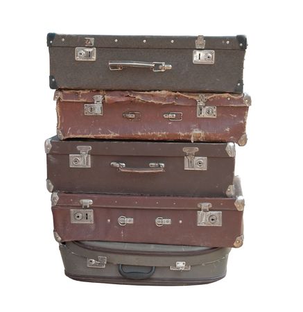   Heap of old suitcases isolated on whiteの写真素材