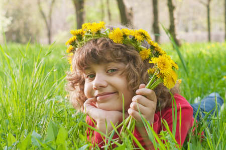 lucky girl reposes on grass の写真素材