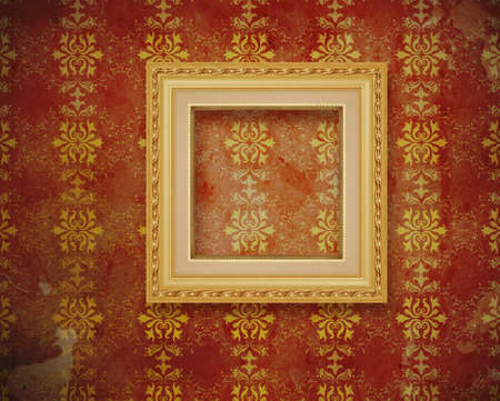 carved gilded frame over old wallpaper の写真素材