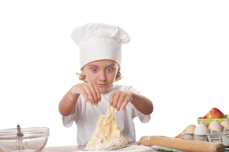 photo of little baker adorable isolated over white background. Cooking concept. の写真素材