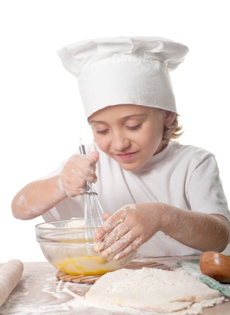photo of little baker adorable, pretty little caucasian girl in chef hat. Cooking concept. の写真素材