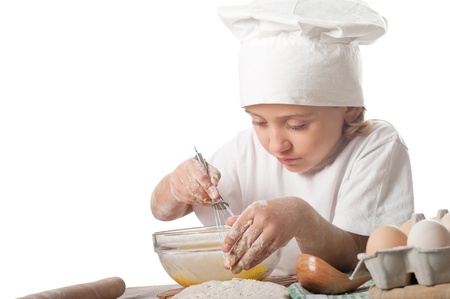 photo of little baker adorable, pretty little caucasian girl in chef hat. Cooking concept. の写真素材