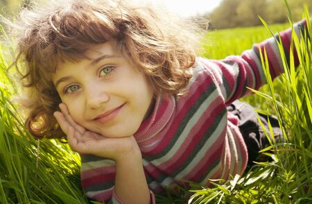 lucky girl reposes on grass の写真素材