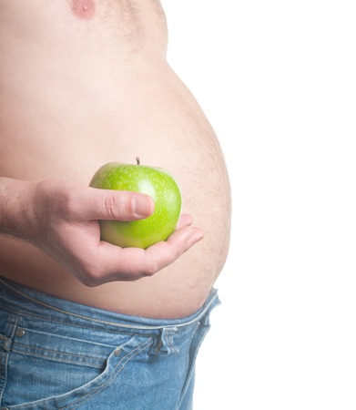 photo of a fat man with a apple in his hand. concept of healthy eating. の写真素材