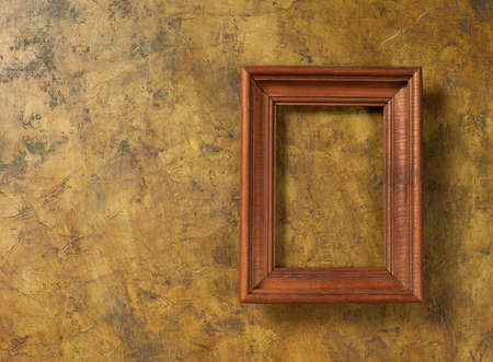wooden photo frame on old wallの写真素材