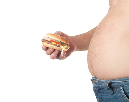 photo of a fat man with a hamburger in his hand の写真素材