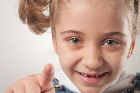 Small girl shows a finger forwards の写真素材