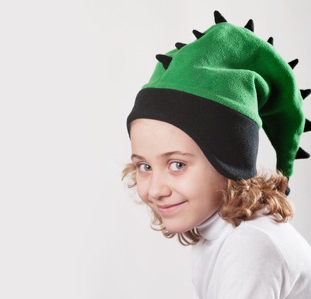 little girl in a cap depicting a dragonの写真素材