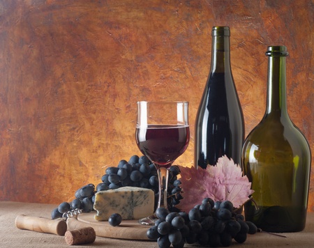 Red wine, cheeses and grapes in a still life setup. の写真素材