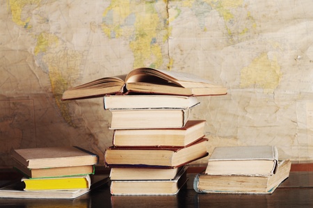 a pile of books on the background mapの写真素材