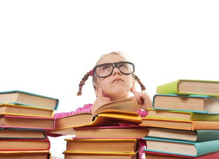 a little girl in glasses thought. back to school concept, isolated over whiteの写真素材