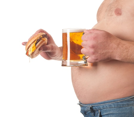 photo of a fat man with a hamburger and beer in his hand の写真素材